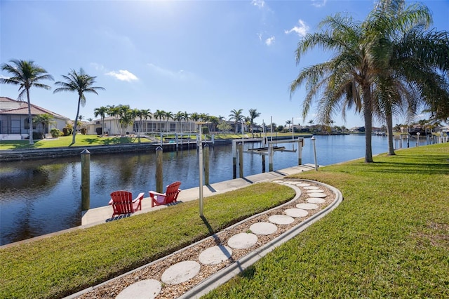 view of dock featuring a yard and a water view