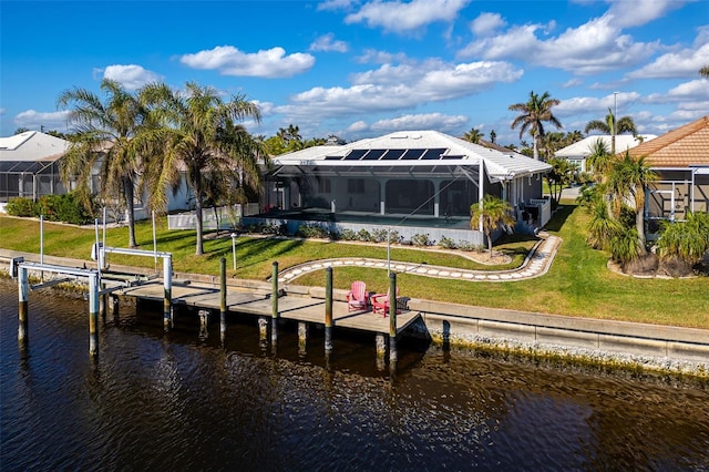 dock area with a yard, a water view, and glass enclosure