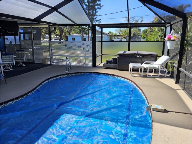 view of swimming pool featuring a patio area, a lanai, and a hot tub