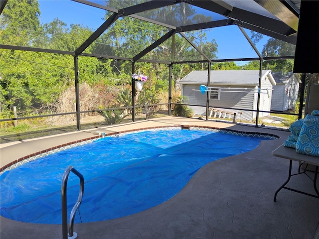 view of swimming pool featuring a storage unit, a lanai, and a patio