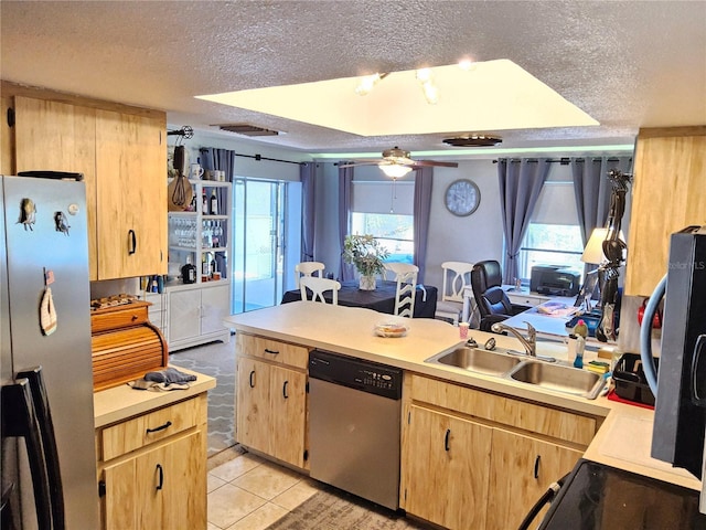 kitchen featuring sink, ceiling fan, a textured ceiling, light tile patterned flooring, and stainless steel appliances