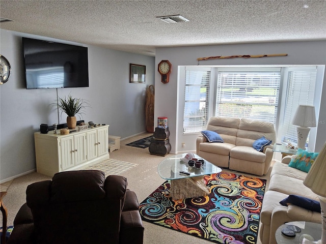 living room featuring carpet floors and a textured ceiling