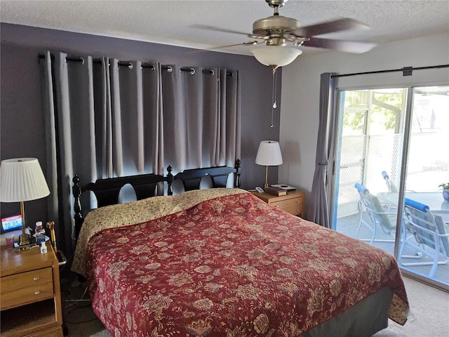 carpeted bedroom with ceiling fan, access to exterior, and a textured ceiling