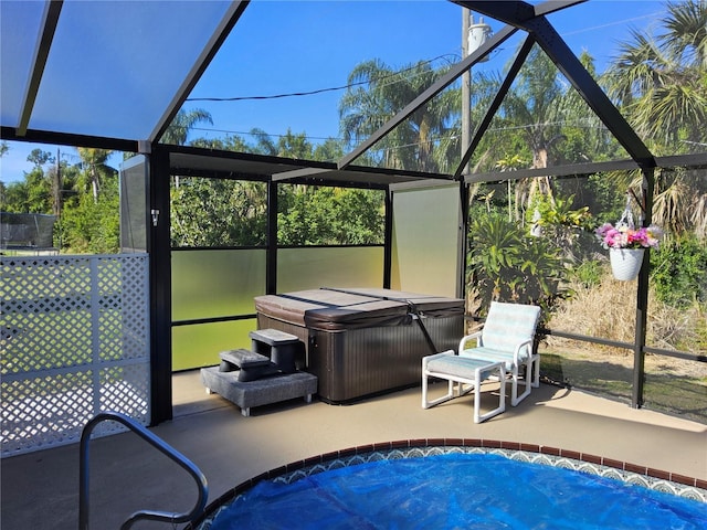 unfurnished sunroom featuring a pool with hot tub