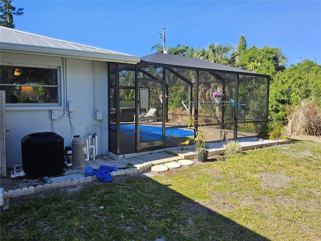 view of yard with cooling unit and a lanai