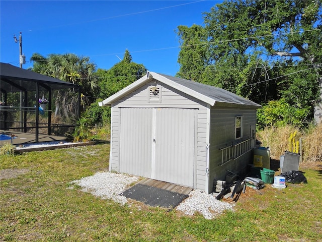 view of outbuilding with a yard