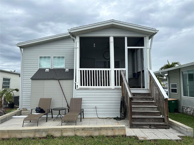 back of house with a patio area and a sunroom