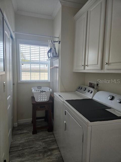 washroom with cabinets, dark wood-type flooring, washer and dryer, and ornamental molding