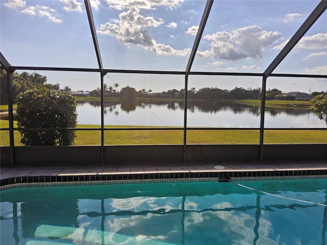 view of swimming pool with a water view and glass enclosure