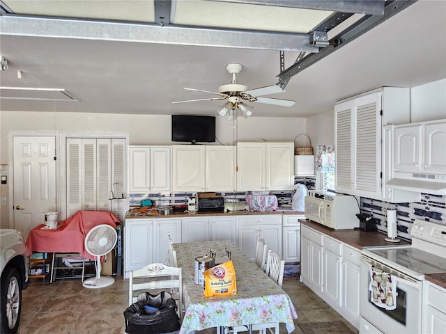 kitchen featuring white cabinetry, a center island, ceiling fan, extractor fan, and white appliances