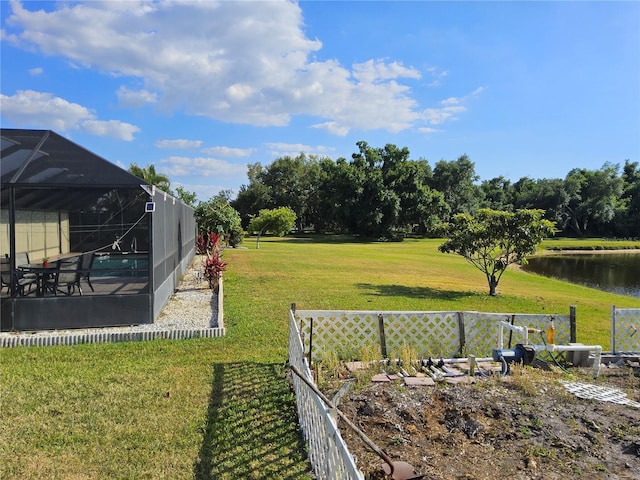 view of yard featuring glass enclosure, a water view, and a pool