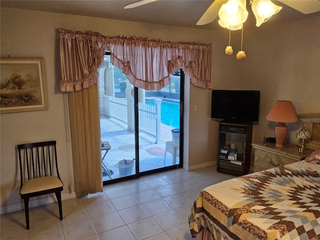 bedroom featuring access to exterior, light tile patterned floors, and ceiling fan