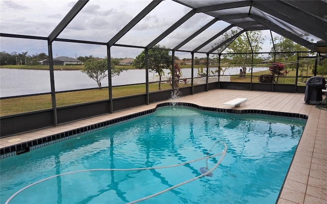 view of swimming pool with glass enclosure, a water view, and a patio