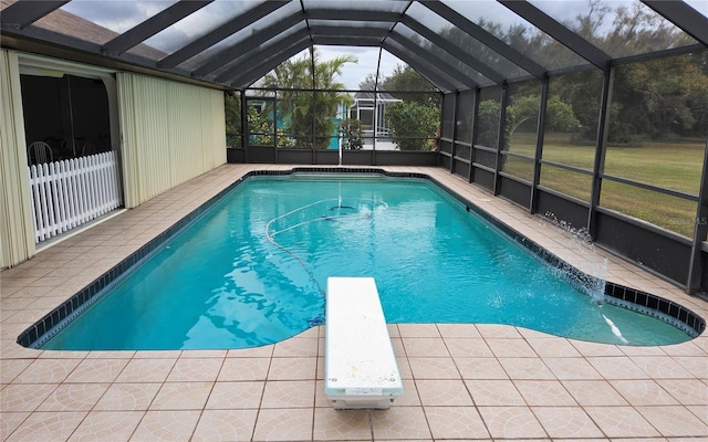 view of swimming pool with a lanai, a diving board, and a patio