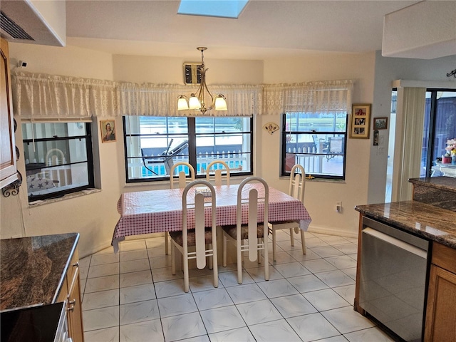 dining area with plenty of natural light, light tile patterned floors, and an inviting chandelier