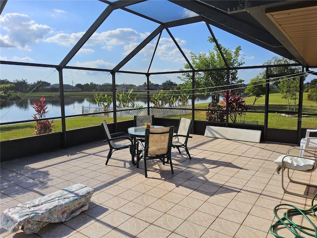 view of patio / terrace with glass enclosure and a water view