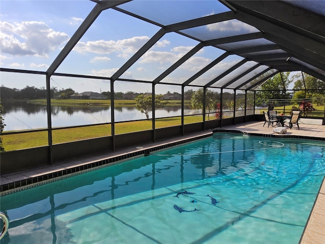 view of pool featuring a patio, a water view, and a lanai