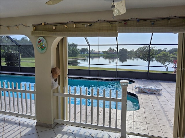 view of pool with a lanai and a water view