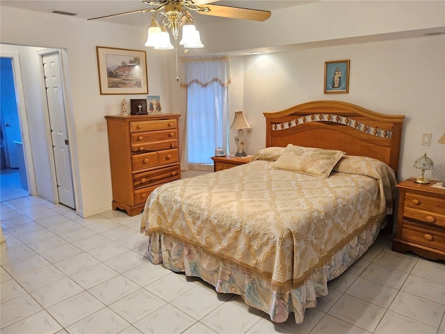 bedroom with ceiling fan and light tile patterned flooring