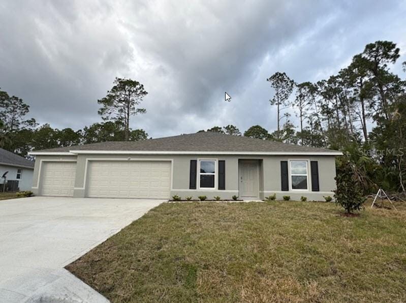 ranch-style home with a front yard and a garage