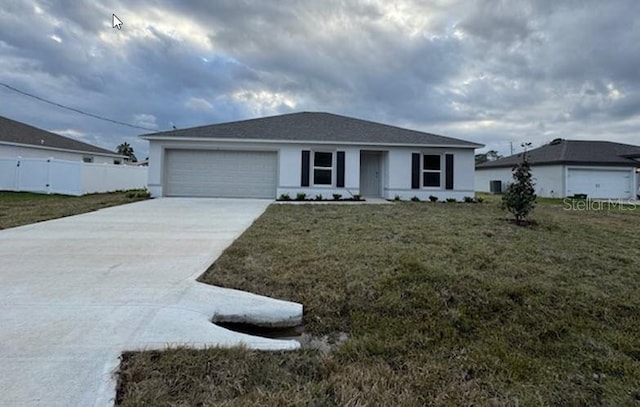 single story home with a front yard and a garage