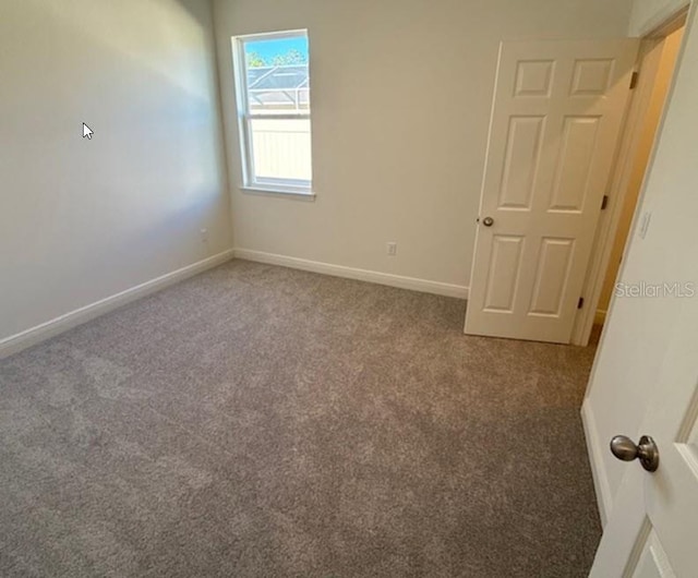 unfurnished room with carpet flooring