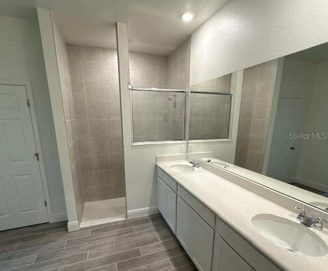 bathroom featuring vanity and a tile shower