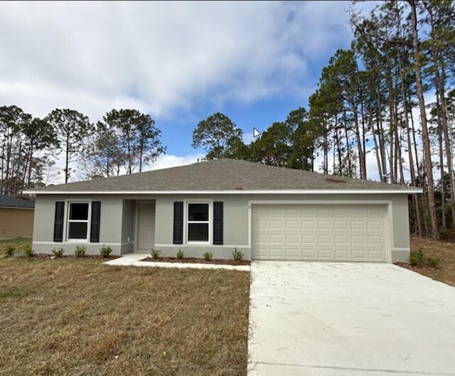 ranch-style home featuring a garage and a front yard