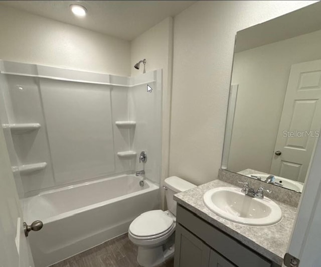 full bathroom with hardwood / wood-style flooring, toilet, vanity, and  shower combination