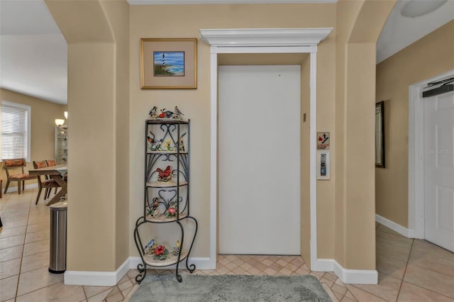 hallway with light tile patterned floors and elevator