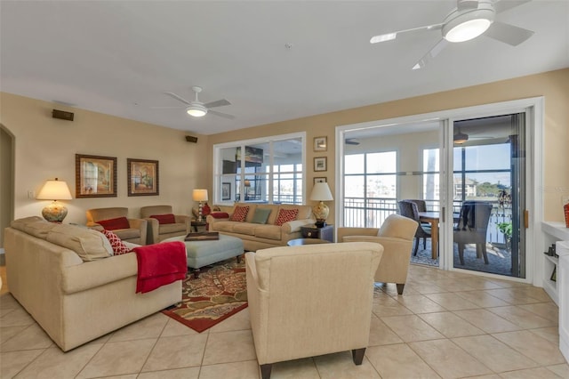 living room with ceiling fan and light tile patterned flooring