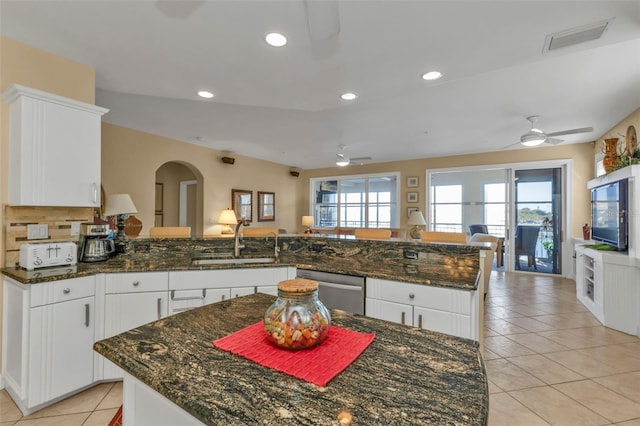 kitchen with white cabinets, dishwasher, kitchen peninsula, and sink