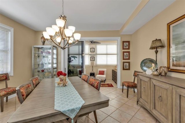 dining room with a wealth of natural light, light tile patterned floors, and a notable chandelier