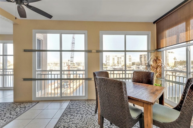 dining space featuring ceiling fan and light tile patterned flooring