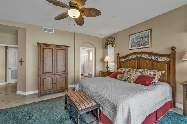 bedroom with ensuite bath, ceiling fan, and light tile patterned floors