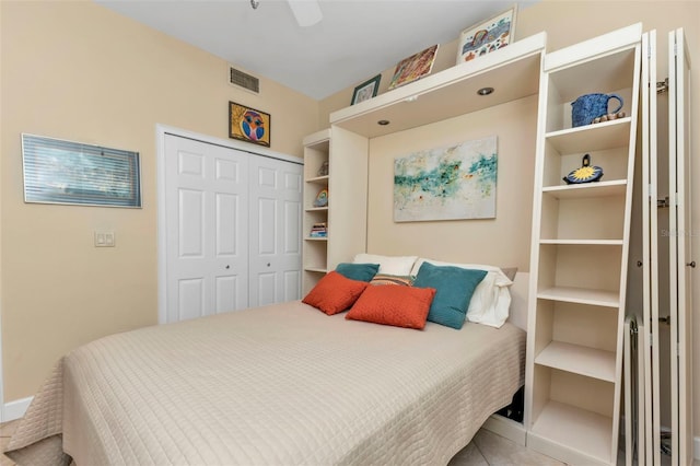 bedroom with ceiling fan and a closet