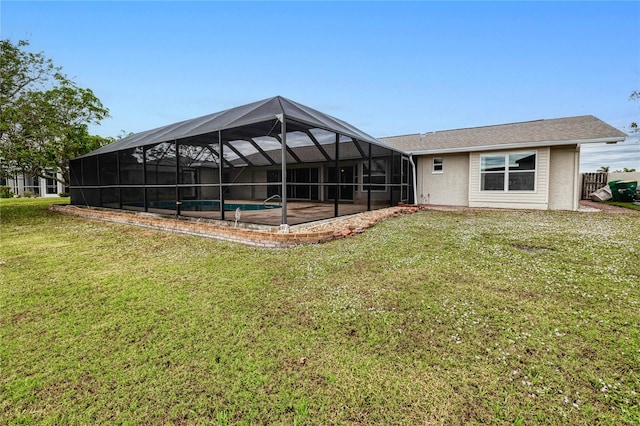 back of property with a lawn and a lanai