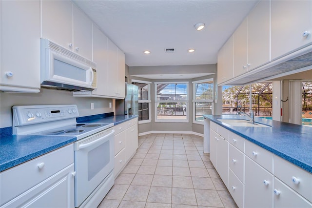 kitchen with sink, white cabinets, and white appliances