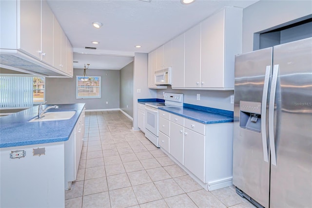 kitchen with white cabinetry, sink, pendant lighting, white appliances, and light tile patterned flooring