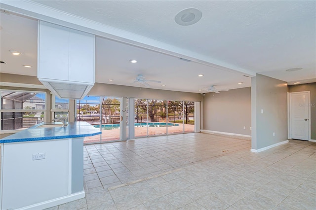 view of swimming pool featuring ceiling fan and sink