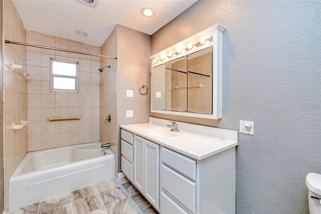 full bathroom with tiled shower / bath combo, toilet, and vanity