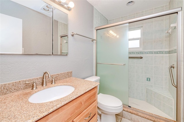 bathroom featuring vanity, toilet, and walk in shower