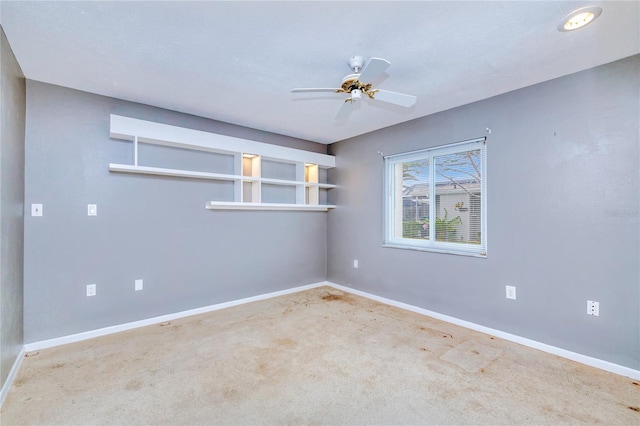 unfurnished room featuring light colored carpet and ceiling fan