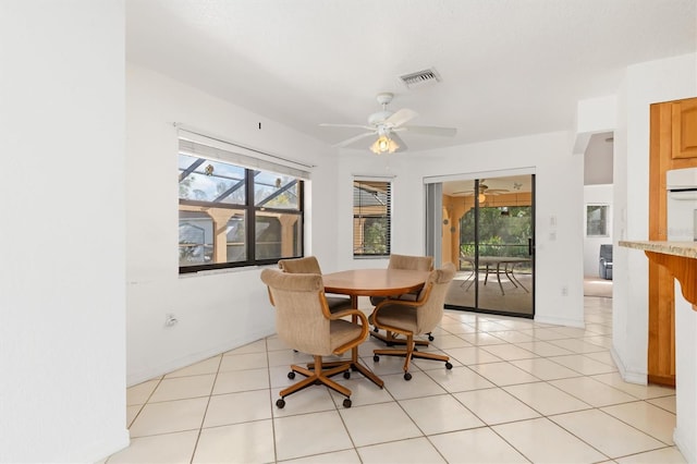 tiled dining room featuring a wealth of natural light