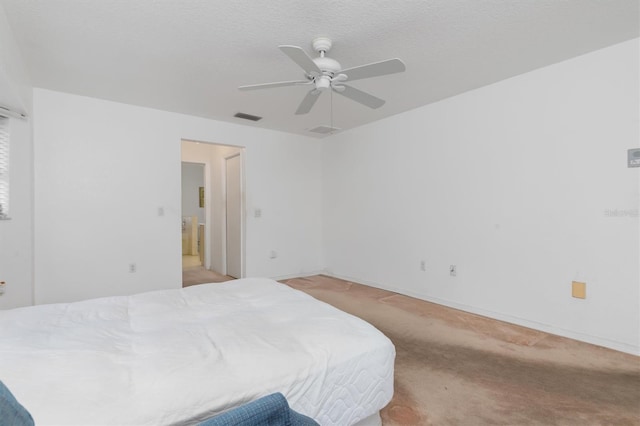 bedroom featuring a textured ceiling, ceiling fan, and light carpet