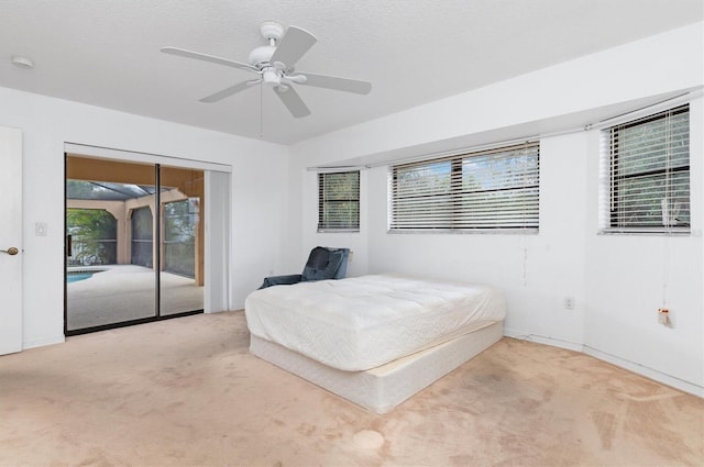 unfurnished bedroom featuring access to outside, multiple windows, ceiling fan, and light carpet