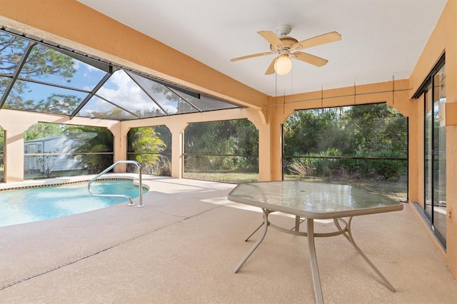 view of swimming pool featuring a lanai, ceiling fan, and a patio area