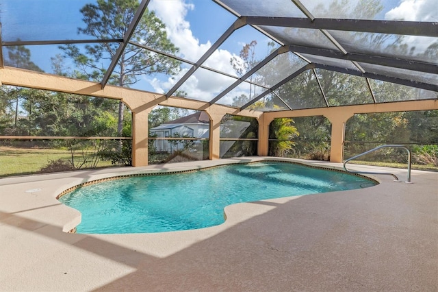 view of pool featuring glass enclosure and a patio