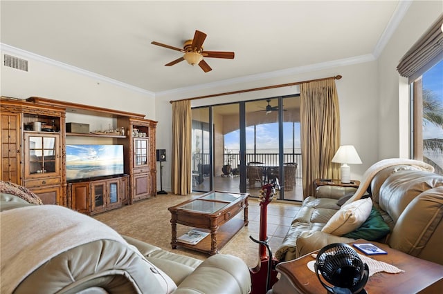 living room with crown molding, ceiling fan, and a healthy amount of sunlight