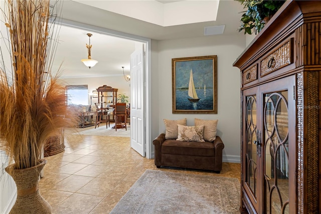 hallway featuring crown molding and light tile patterned floors